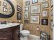 Small bathroom with dark wood vanity and framed artwork at 18059 W Tierra Del Sol Dr, Surprise, AZ 85387