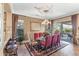 Elegant dining room with chandelier, large windows, and seating for six at 18059 W Tierra Del Sol Dr, Surprise, AZ 85387