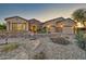 Beautiful stone and stucco home with a welcoming front porch at 18059 W Tierra Del Sol Dr, Surprise, AZ 85387