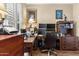 Home office with L-shaped desk and multiple monitors at 18059 W Tierra Del Sol Dr, Surprise, AZ 85387