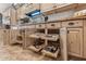 Well-organized kitchen with pull-out shelves, granite countertops, and ample cabinet space at 18059 W Tierra Del Sol Dr, Surprise, AZ 85387