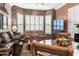 Spacious living room with stone fireplace and large windows at 18059 W Tierra Del Sol Dr, Surprise, AZ 85387