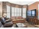 Living area features a stone accent wall and comfortable leather furniture at 18059 W Tierra Del Sol Dr, Surprise, AZ 85387