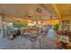 Covered patio with seating areas and views of the pool and landscape at 18059 W Tierra Del Sol Dr, Surprise, AZ 85387