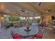 Covered patio with seating area, multiple fans, and pool view at 18059 W Tierra Del Sol Dr, Surprise, AZ 85387