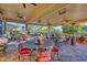 Covered patio with seating areas and views of the backyard at 18059 W Tierra Del Sol Dr, Surprise, AZ 85387