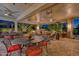 Spacious covered patio with multiple seating areas, ceiling fans, and heaters at 18059 W Tierra Del Sol Dr, Surprise, AZ 85387