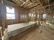 Partially framed bedroom showcasing window placements, wooden framing, and drywall ready for installation at 22820 E Lords Way, Queen Creek, AZ 85142