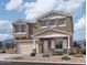 Two-story house with beige exterior, three-car garage, and landscaping at 22820 E Lords Way, Queen Creek, AZ 85142