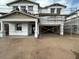 Two-story home exterior under construction with visible framework, scaffolding, and partial roof installation at 22820 E Lords Way, Queen Creek, AZ 85142