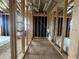 Framed hallway showcasing wooden framing, electrical and plumbing, and open layout for customization at 22820 E Lords Way, Queen Creek, AZ 85142