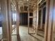 Spacious room featuring modern construction with exposed beams and plywood flooring at 22820 E Lords Way, Queen Creek, AZ 85142
