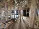 Spacious room featuring modern construction with exposed beams and plywood flooring at 22820 E Lords Way, Queen Creek, AZ 85142