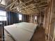 Open living space with wooden framing, multiple windows for natural light, and drywall for installation at 22820 E Lords Way, Queen Creek, AZ 85142