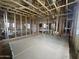 Open living space with wooden framing, multiple windows for natural light, and drywall ready for installation at 22820 E Lords Way, Queen Creek, AZ 85142