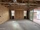 Unfinished living room under construction featuring exposed framing, large windows, and a sliding glass door at 22820 E Lords Way, Queen Creek, AZ 85142