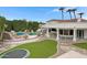 Sprawling property with an inground pool, outdoor kitchen, expansive lawn, and multiple entertainment spaces at 321 N Portland Ave, Gilbert, AZ 85234