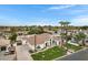 Expansive aerial view showcasing a luxury home with a tile roof surrounded by lush landscaping and mature trees at 321 N Portland Ave, Gilbert, AZ 85234