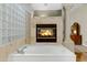 Luxurious bathroom showcasing a soaking tub and an inviting fireplace at 321 N Portland Ave, Gilbert, AZ 85234