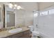 Bright bathroom featuring a granite countertop vanity and a shower-over-tub combination at 321 N Portland Ave, Gilbert, AZ 85234
