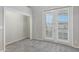 Bright bedroom with french doors leading outside and neutral carpet at 321 N Portland Ave, Gilbert, AZ 85234