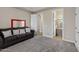 Comfortable bedroom featuring a dark sofa with decorative pillows, with ensuite bathroom at 321 N Portland Ave, Gilbert, AZ 85234