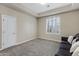 Cozy bedroom with a neutral palette, plush carpet, and plantation shutters for adjustable natural light at 321 N Portland Ave, Gilbert, AZ 85234