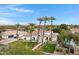 Stunning white home featuring desert landscaping, a circular driveway, and mature palm trees at 321 N Portland Ave, Gilbert, AZ 85234