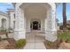 Covered front entrance with stone columns highlighting a walkway leading to the front door at 321 N Portland Ave, Gilbert, AZ 85234
