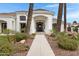 Grand front entrance with decorative landscaping and stone pathway leading to the home's front door at 321 N Portland Ave, Gilbert, AZ 85234