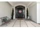 Inviting front porch with chairs and decorative pillows, complemented by an elegant front door at 321 N Portland Ave, Gilbert, AZ 85234