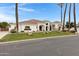 Stunning single-story home featuring a well-manicured lawn and a beautiful white stucco exterior with a tile roof at 321 N Portland Ave, Gilbert, AZ 85234