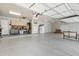 Clean three-car garage featuring epoxy flooring and custom built-in storage solutions at 321 N Portland Ave, Gilbert, AZ 85234