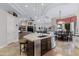Open-concept kitchen and dining area with a spacious island, modern appliances, and stylish decor at 321 N Portland Ave, Gilbert, AZ 85234