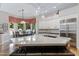 Stylish kitchen with a large island, modern lighting, and stainless steel appliances overlooking the backyard at 321 N Portland Ave, Gilbert, AZ 85234