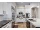A gourmet kitchen with stainless steel appliances, custom cabinets, and black granite countertops at 321 N Portland Ave, Gilbert, AZ 85234