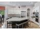 Gorgeous kitchen featuring a huge island with seating, white cabinets, and modern stainless steel appliances at 321 N Portland Ave, Gilbert, AZ 85234
