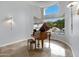 Elegant living room featuring grand piano and a large window overlooking the pool area at 321 N Portland Ave, Gilbert, AZ 85234