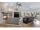 Spacious living room with high ceilings, a brick fireplace, and plenty of natural light at 321 N Portland Ave, Gilbert, AZ 85234