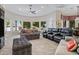 Well-lit living room featuring walls of windows and access to the outdoor pool and gardens at 321 N Portland Ave, Gilbert, AZ 85234