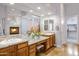 Bright main bathroom featuring double sinks, granite countertops and a cozy fireplace at 321 N Portland Ave, Gilbert, AZ 85234