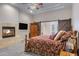 Cozy main bedroom with a fireplace, barn door, and a comfortable patterned bed at 321 N Portland Ave, Gilbert, AZ 85234