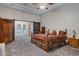 Spacious main bedroom showcasing barn doors, a ceiling fan, and a patterned bedspread at 321 N Portland Ave, Gilbert, AZ 85234