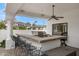 A fully equipped outdoor kitchen with a built-in grill, bar seating, and ample counter space at 321 N Portland Ave, Gilbert, AZ 85234