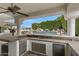 Fully-equipped outdoor kitchen and bar area overlooking the backyard pool and landscaping at 321 N Portland Ave, Gilbert, AZ 85234