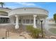 Expansive outdoor living area with covered seating and cooling misting system overlooking manicured landscaping at 321 N Portland Ave, Gilbert, AZ 85234
