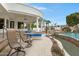 Outdoor patio with lounge chairs overlooking the pool and backyard, perfect for relaxing and entertaining at 321 N Portland Ave, Gilbert, AZ 85234