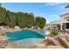 Luxury backyard pool with rock features, a water slide, and a built-in spa, surrounded by a lush backyard at 321 N Portland Ave, Gilbert, AZ 85234
