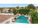 Stunning backyard pool featuring a rock waterfall, waterslide, hot tub, and pristine landscaping at 321 N Portland Ave, Gilbert, AZ 85234