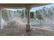 Luxury pool area with misting system, rock features, and a built-in volleyball net for recreation at 321 N Portland Ave, Gilbert, AZ 85234